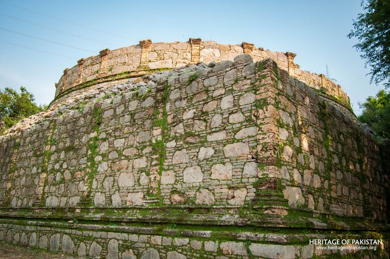 Weathered stone surface displays characteristic moss growth patterns.